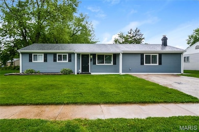 Ranch-style house with a front lawn, a chimney, driveway, and roof with shingles