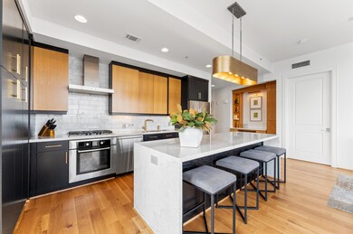 This modern kitchen features sleek black and wood