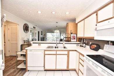 Kitchen with sink, a notable chandelier, decorativ