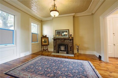 Living room with decorative fireplace & renovated 