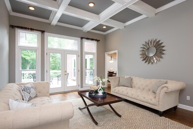 The gorgeous coffered ceiling, and the direct view of the mature treed back makes this room look grand