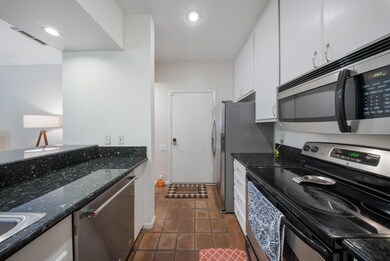 Modern kitchen with granite countertops, bar seati