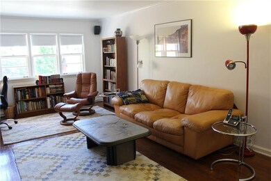 Living room with bright windows, high ceilings, an