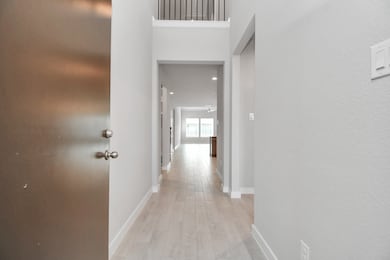 As you step into the threshold of this luxurious home, you'll soon be welcomed by an elegant glass door (to be installed). Inside, soaring ceilings amplify the spaciousness, while the refined wood-look tile flooring and oversized baseboards exude sophistication and charm. Sample photo of completed home with similar floor plan. Actual colors and selections may vary.
