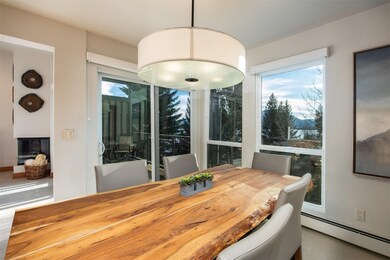 Dining Area with large windows, large sliding door, and lake and mountain views