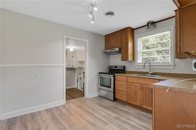 Kitchen featuring under cabinet range hood, visibl