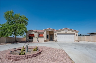 View of front of house with driveway, stucco siding, a tile roof, and an attached garage