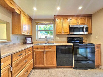 ANOTHER VIEW OF THE KITCHEN WITH WINDOW LETTING IN