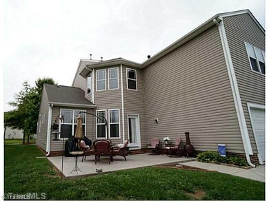 Exterior Back. Spacious patio and attached garage!