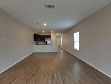 Unfurnished living room featuring dark wood finis