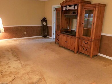 Large living room perfect for family time. Chair rail molding.