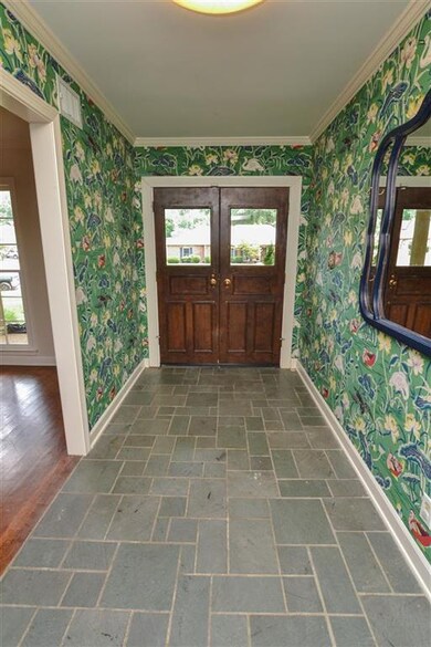 Leads into living room and double doors to den