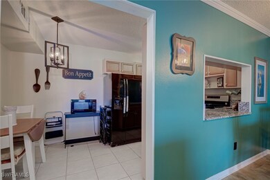 Dining room with a textured ceiling, crown molding