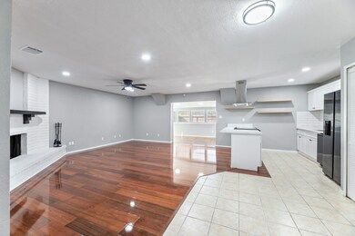 Open floor plan, Kitchen featuring light countertops, a ceiling fan, white cabinets, new appliances, recessed lighting, and open shelves