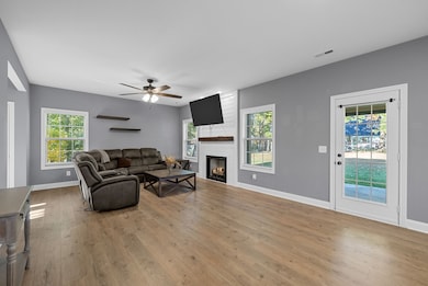 Large living room with fireplace and door leading out to the covered patio