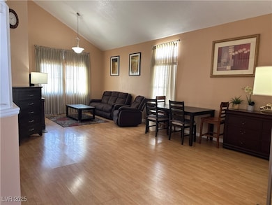 Living area with light wood-style floors and high