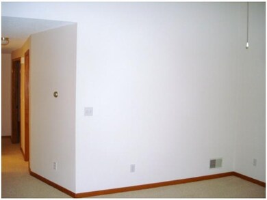 Great Room. Looking towards back of condo.  Carpet