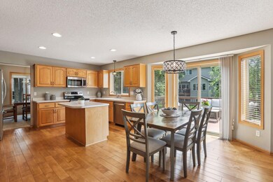 Engineered wood flooring, stainless steel appliances, wood cabinets, indoor/outdoor living space with maintenance free decking