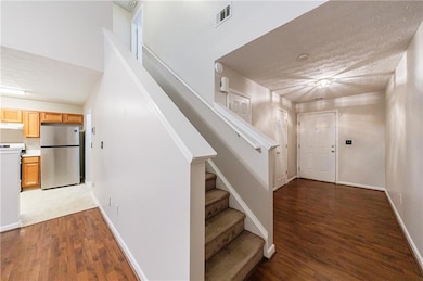 Entrance foyer with wood finished floors and stairway