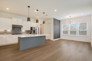 Kitchen with stainless steel fridge, under cabine