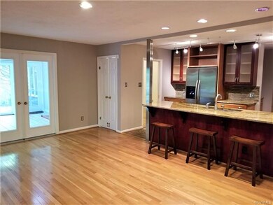Ceramic tile kitchen and hardwoods at eat in area