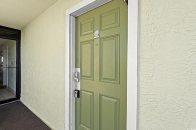 Property entrance featuring stucco siding