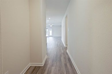 Bright hallway with light-colored walls and wood f