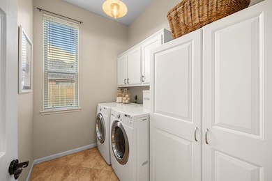 This photo shows a bright laundry room with white