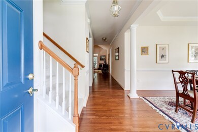 Foyer Entrance with Hardwood Flooring and Crown Molding.
