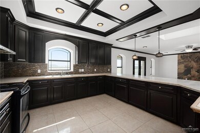Kitchen featuring tasteful backsplash, electric range, pendant lighting, light tile floors, and ceiling fan