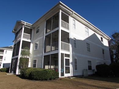 Back of house featuring screen porch.