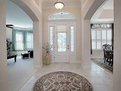 Beautiful leaded-glass entry to the tiled foyer.