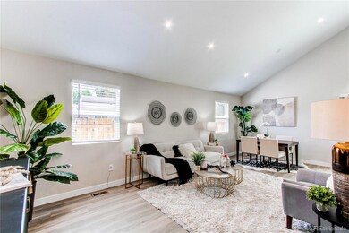 Gorgeous vaulted ceilings in living room with new canister lighting and window coverings.