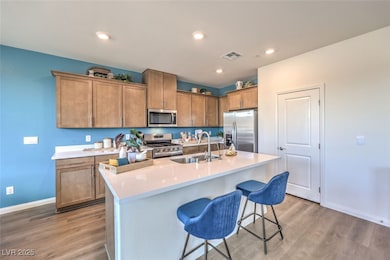 Kitchen featuring a sink, a breakfast bar, light w