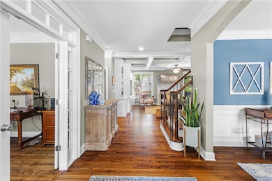 Entry featuring hardwood floor and crown molding