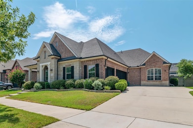View of front of house with a front yard and a gar