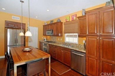 The custom mosaic tile backsplash complements the 
