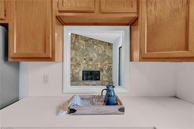 The pass through in the kitchen allows for  the ease of entertainment and creates a more open and connected living space.
