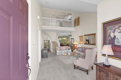 Tile entrance foyer with stairway, a ceiling fan, 