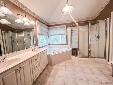 Bathroom with tile patterned flooring, vanity, vau