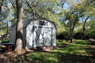 View of outdoor structure featuring a yard