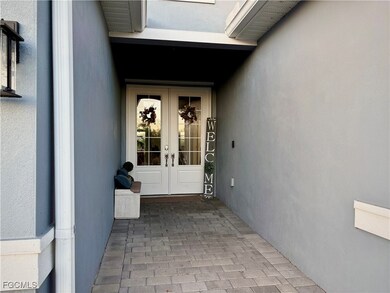 Property entrance featuring french doors and stucco siding