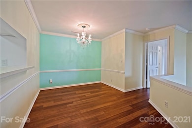Dining Room features crown molding, custom chandelier & bamboo floors!