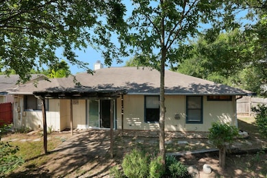 View of front of house featuring a chimney, a pat