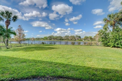 View of yard featuring a water view and fence