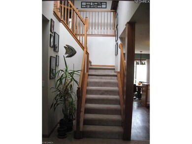 Open Stairway Features Three Level Gallery Walls