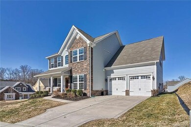 Stone front, rocking chair porch, 2 car garage wit