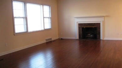 Expansive living room with gas insert fireplace.