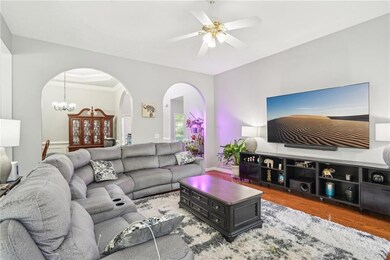 Living room with arched walkways, wood finished fl