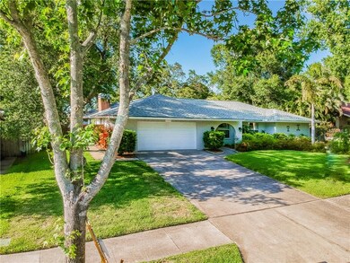 Spacious driveway and mature landscaping make this